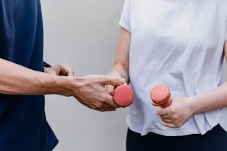 a man and a woman holding dumbs in their hands